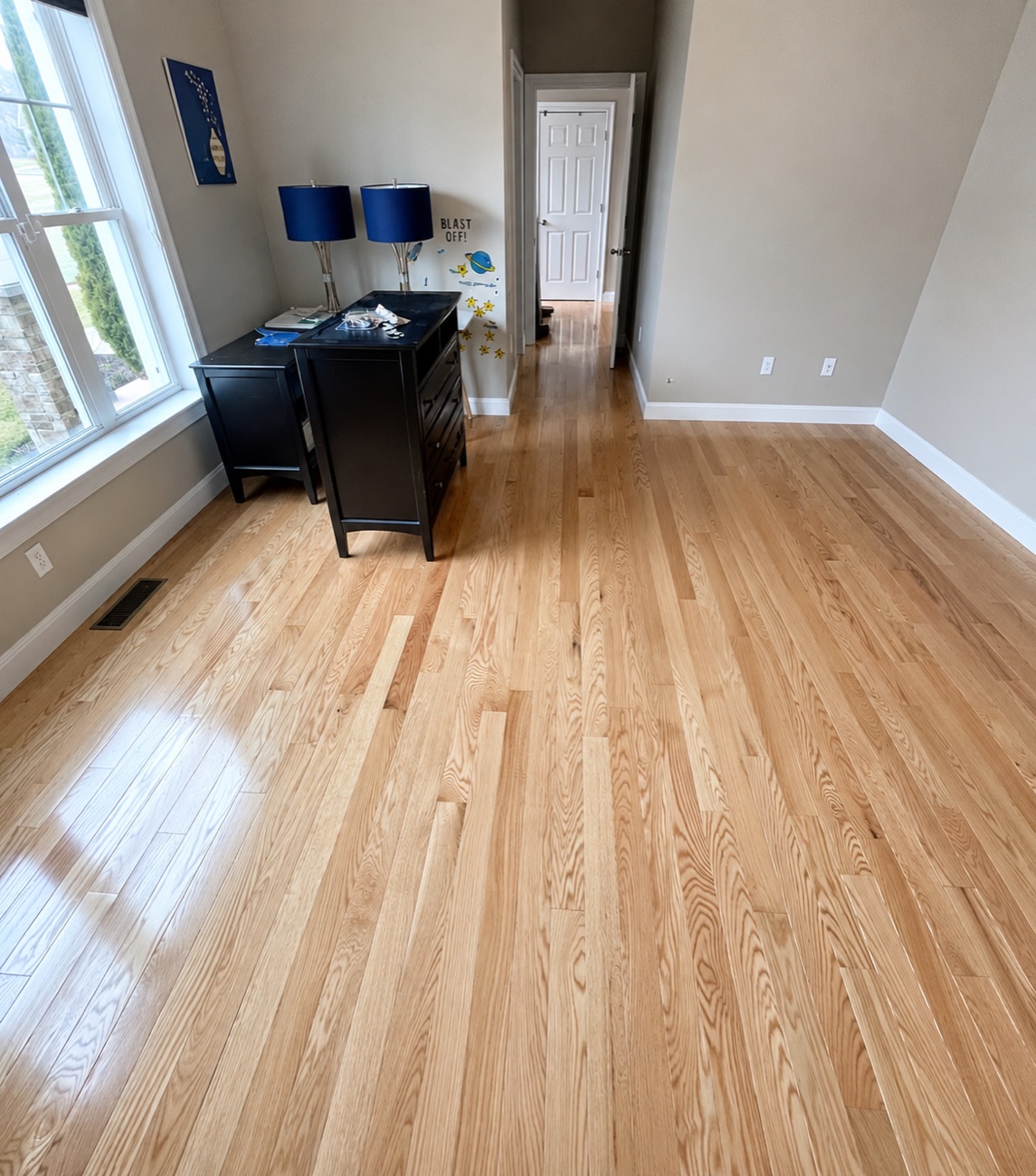 Finished red oak hardwood floor in a furnished room